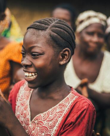 Smiling girl with braided hair in red dress