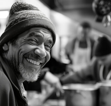 Smiling man wearing beanie in kitchen