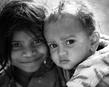 Black-and-white close-up portrait of two children