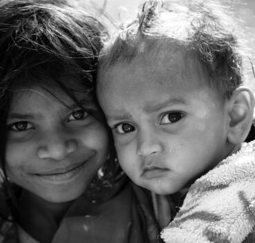 Black-and-white close-up portrait of two children