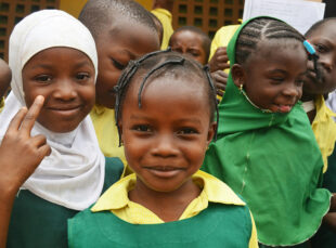 Smiling schoolchildren in green uniforms