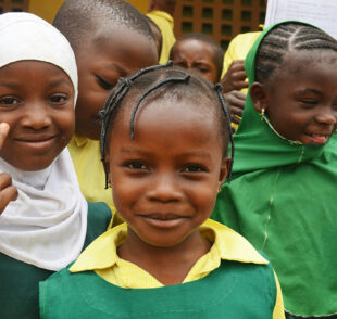 Smiling schoolchildren in green uniforms