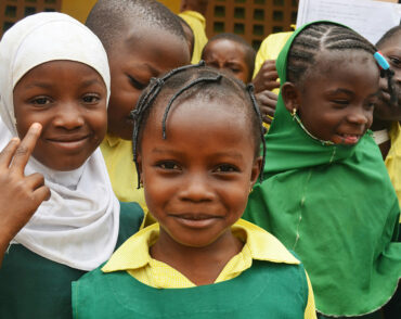 Smiling schoolchildren in green uniforms