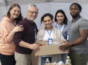Volunteers holding food box at donation drive