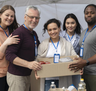 Volunteers holding food box at donation drive