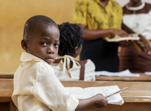Young student at desk in classroom