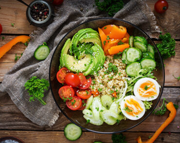 Colorful Buddha bowl with avocado and eggs